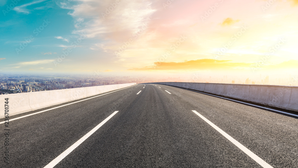 Fototapeta premium Panoramic city skyline and buildings with empty asphalt road at sunset