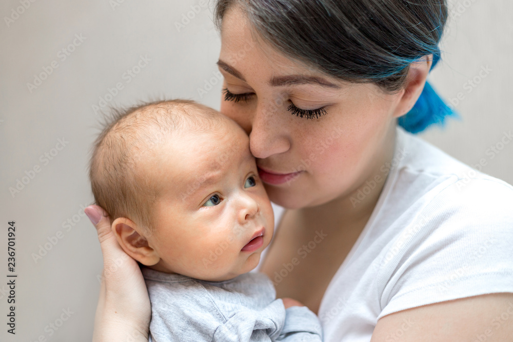 Young mother holding her newborn child. Mom nursing baby. Young mother holding her newborn child. Mom nursing baby.