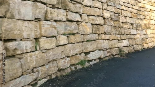 Retaining wall from granite blocks in residential street in Andalusian village