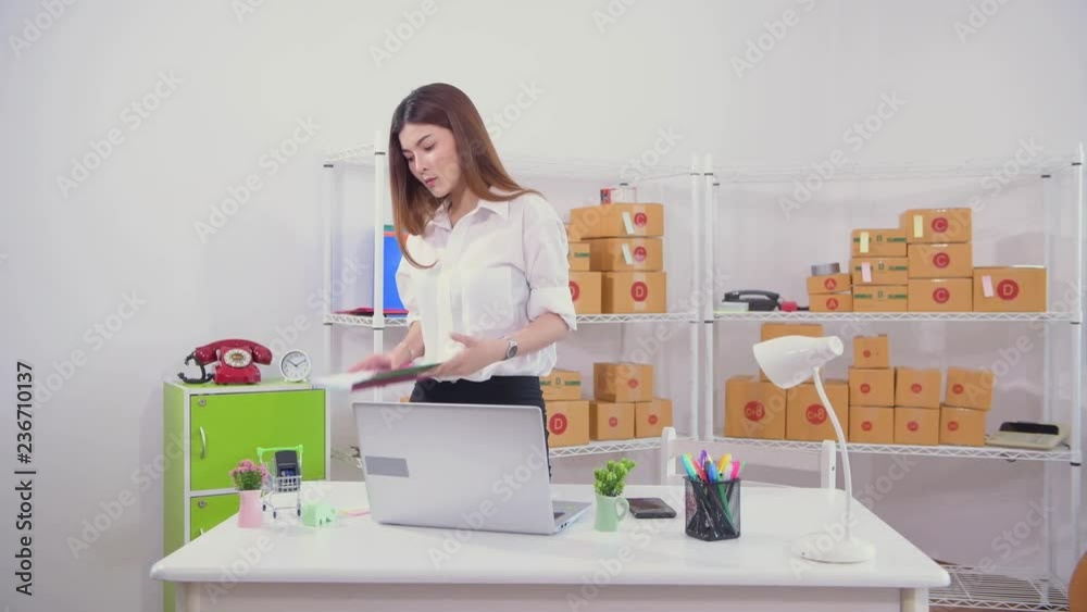 Young woman with online business working using laptop and check shipping packages Young woman with online business working using laptop and check shipping packages