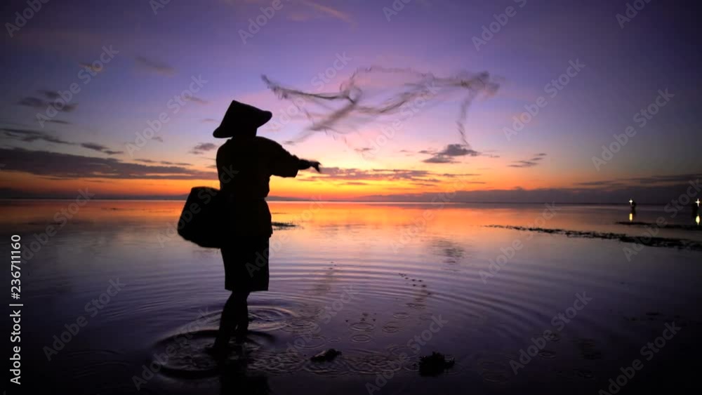 Outdoor occupation of a Balinese fisherman casting traditional fishing net