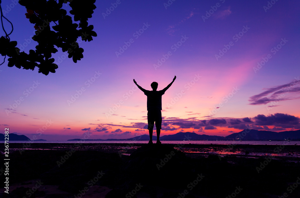 Alone man standing holding his hand up and see landscape scenery view in sunset time Alone man standing holding his hand up and see landscape scenery view in sunset time