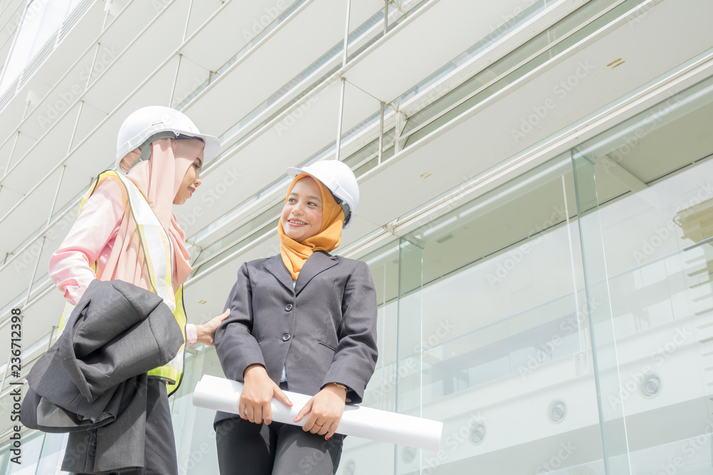 Professional woman engineers are discussing on construction at outdoor. Professional woman engineers are discussing on construction at outdoor.