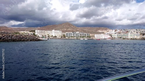 Boat trip to Port Anfi, Cran Canaria. Filmed from boat . dark blue water. photo