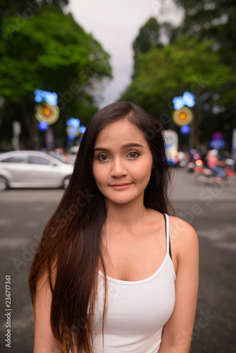 Young beautiful Asian tourist woman exploring Ho Chi Minh city i