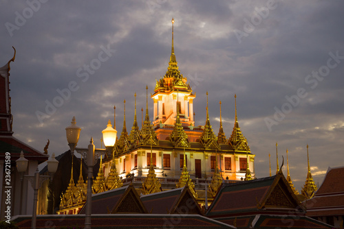 The Temple of Loha Prasat in the cloudy evening twilight. Bangkok, Thailand © sikaraha