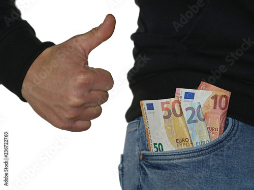 man in blue jeans showing thumb up and euro banknotes, money in the pocket isolated on white background photo