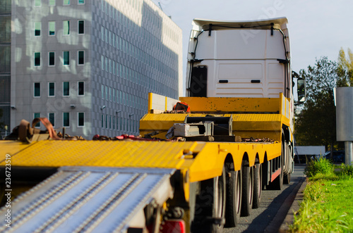 big yellow truck standing by the road