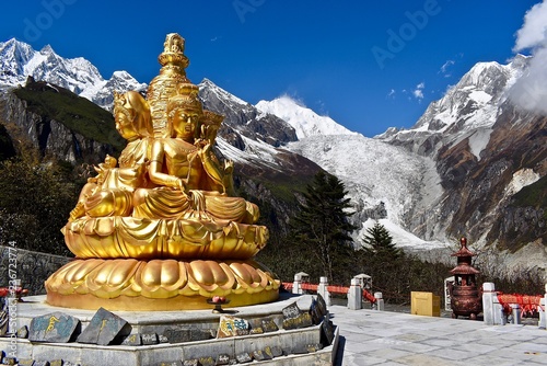 Golden statue and Mt. Gongga in the background, Sichuan, China  photo