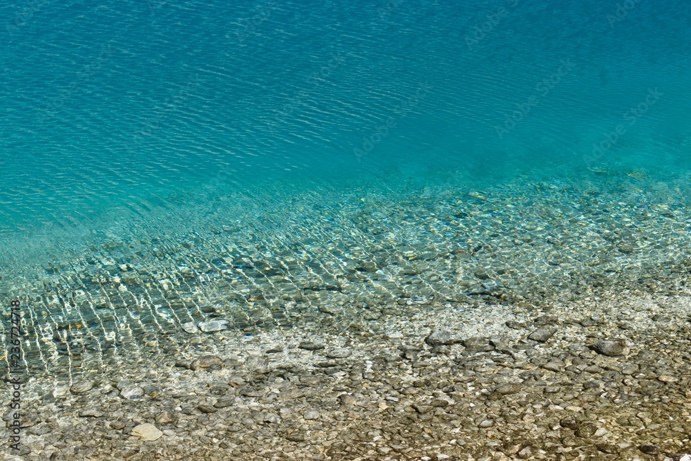 Unique crystal clear water of the Milk lake (approx. 4300m altitude) in Daocheng Yading Nature Reserve, Sichuan, China.  