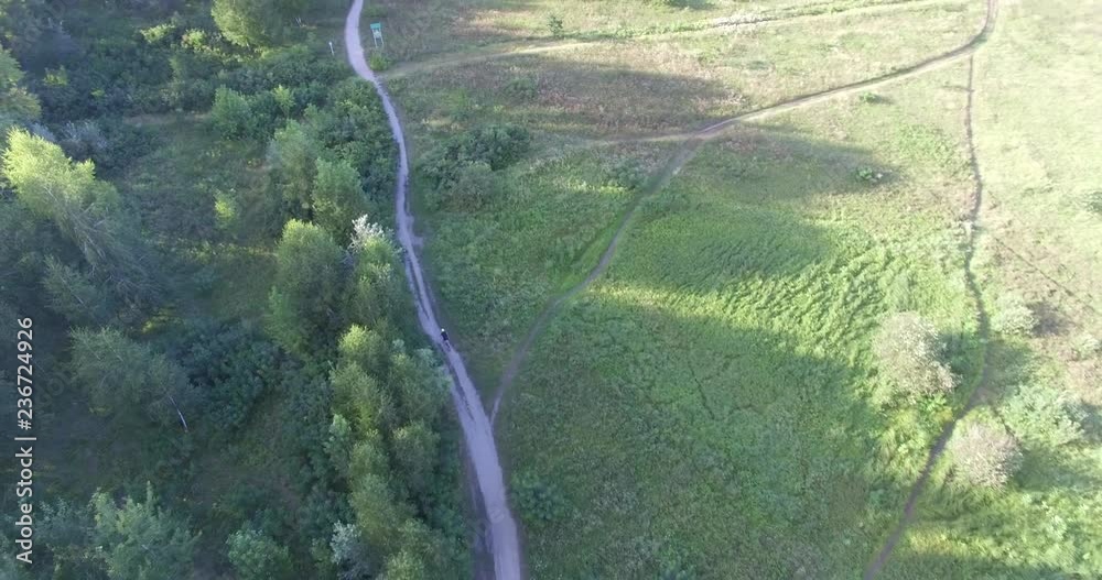Cycling Aerial. Cyclist From Drone. MTB Cyclist Aerial View.Man Ride Bike On Rural Road.Healthy man cycling MTB bicycle outdoors fitness. Cycling Aerial. Cyclist From Drone. MTB Cyclist Aerial View.Man Ride Bike On Rural Road.Healthy man cycling MTB bicycle outdoors fitness.