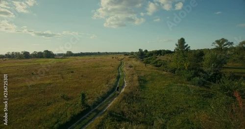 Wallpaper Mural Aerial mtb. MTB bike cycling riding from drone.Senior man riding mountain bike.Aerial: man cycling along country road.Drone flying above cyclist ride on gravel road. Drone cyclocross and mtb riding. Torontodigital.ca