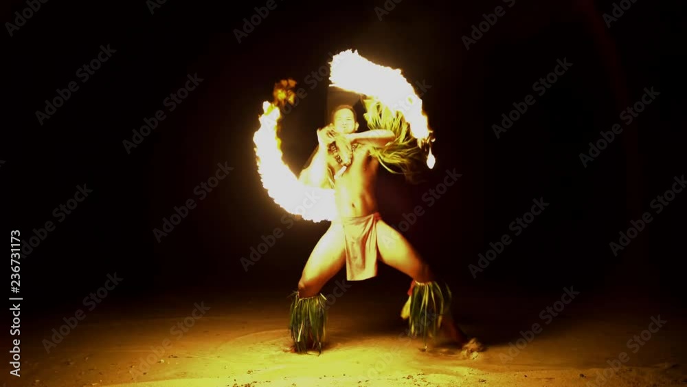 Male Fire dancer with illuminated spinning flaming torch performing the Art of Fire dancing a traditional culture in French Polynesia South Pacific