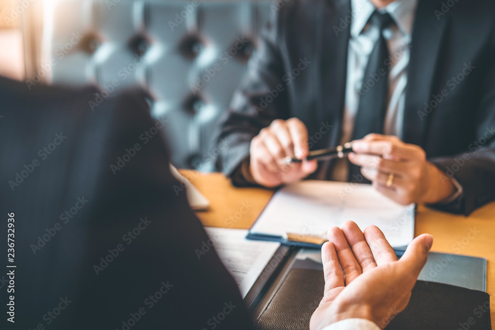 Senior manager reading a resume during a job interview employee young man meeting Applicant and recruitment concept Senior manager reading a resume during a job interview employee young man meeting Applicant and recruitment concept