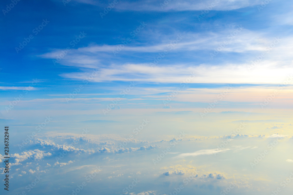 Sun rise in the morning of blue sky above the white clouds and land  background with golden light looking through an airplane window Stock Photo  | Adobe Stock