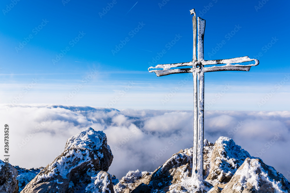 Frosted cross on a mountain peak Velky Rozsutec in Mala Fatra in Slovakia. Frosted cross on a mountain peak Velky Rozsutec in Mala Fatra in Slovakia.