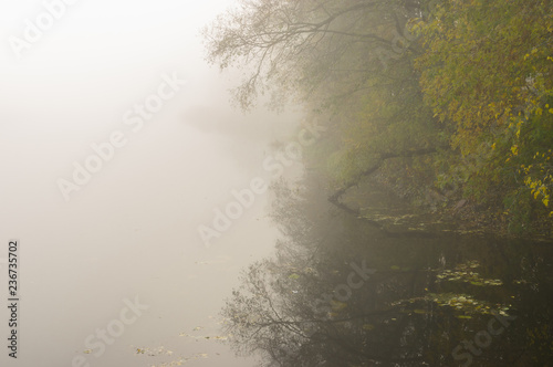 Fog over Vorskla river at autumnal morning, Ukraine photo