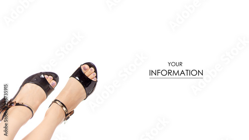 Female legs feet black sandals shoes pattern on white background isolation