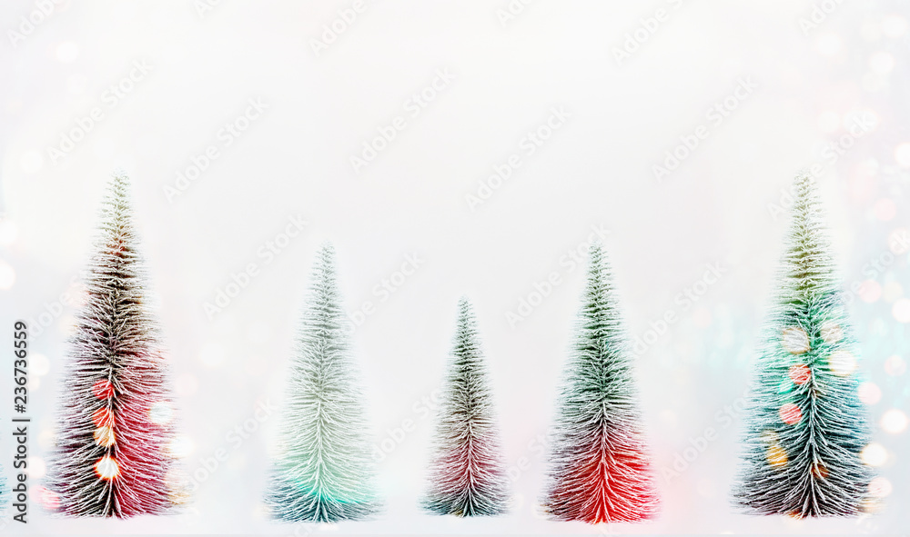 Decorative Christmas trees with sunshine bokeh on white background, banner or template. Fir trees forest