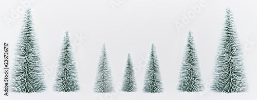 Decorative Christmas fir trees forest on white background, banner