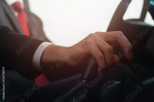 Hand Of A Young Man In Formal Clothes Shifts the Gearbox