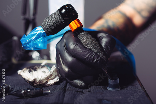 Master tattoo artist prepares tools for tattooing © zorandim75