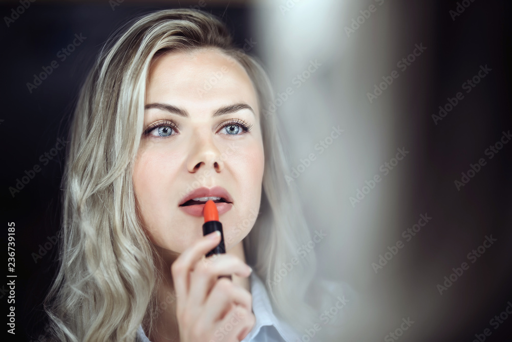 girl in front of the mirror chooses lipstick girl in front of the mirror chooses lipstick