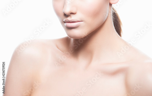 Part of beauty face and body of young adult woman with clean fresh skin, natural make-up. Isolated. White background