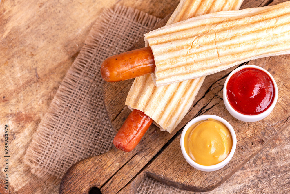 Two tasty grilled french hot dog with mustard and ketchup Two tasty grilled french hot dog with mustard and ketchup