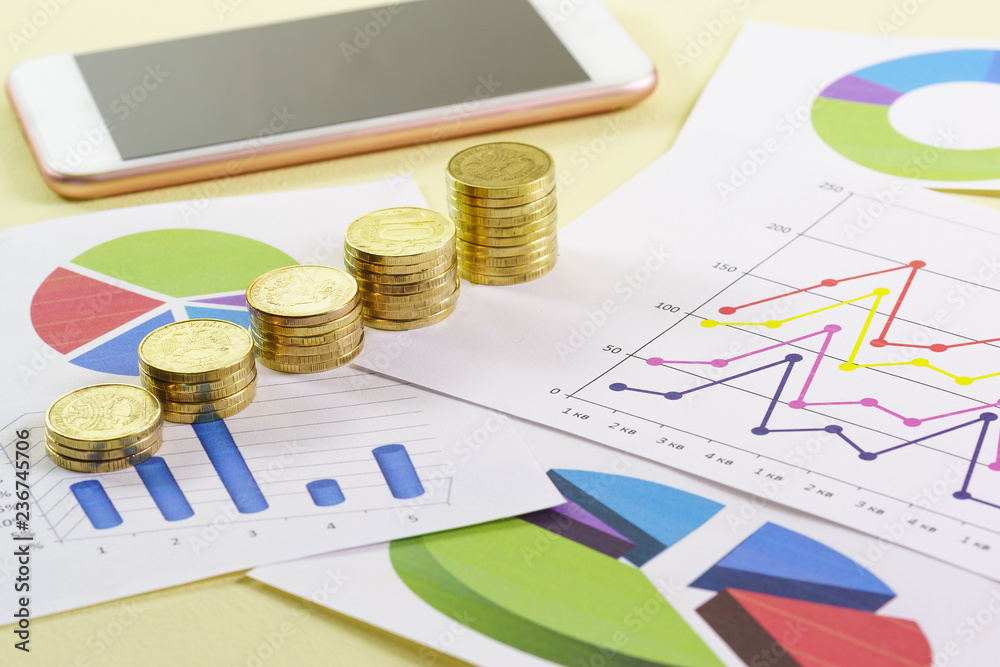 Increasing in the size of the stack of gold coins are on colored charts. Visual analysis of the state of the business