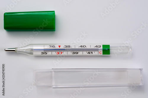 Glass medical thermometer thermometer for measuring body temperature shot on a white background