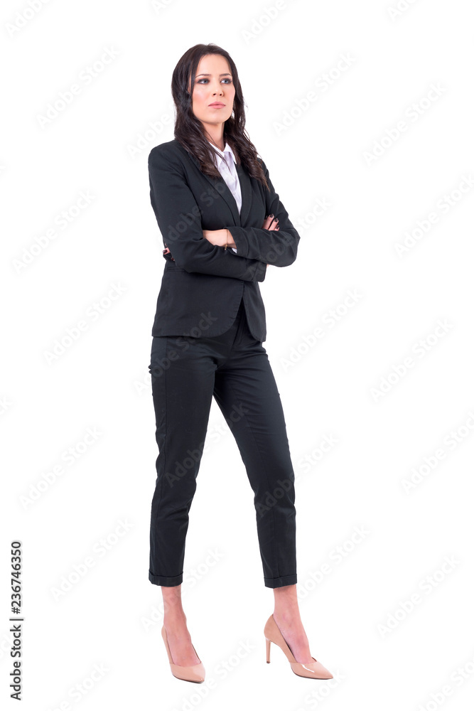 Serious skeptical business woman with crossed arms in elegant black suits looking away. Full body isolated on white background. Serious skeptical business woman with crossed arms in elegant black suits looking away. Full body isolated on white background.