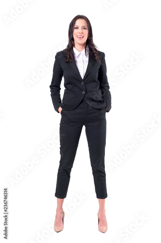 Relaxed confident business woman in suit smiling and looking at camera. Success concept. Full body isolated on white background. 