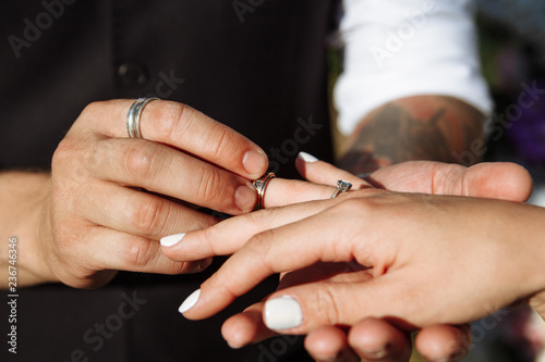 wedding couple wearing gold finger rings
