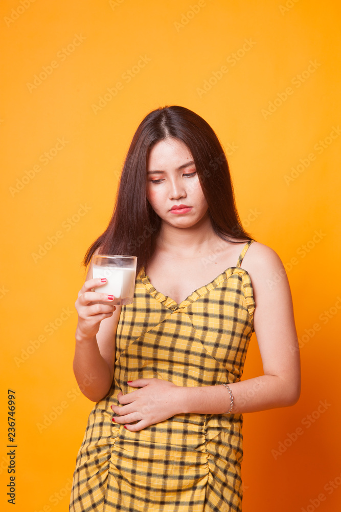 Asian woman drinking a glass of milk got stomachache.