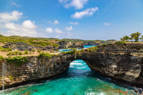 Beautiful landscape of a Broken Beach, located in Nusa Penida Island, the southeast island of Bali, Indonesia. The amazing tourist attraction of the rock, cliff, mountain, and ocean waves.