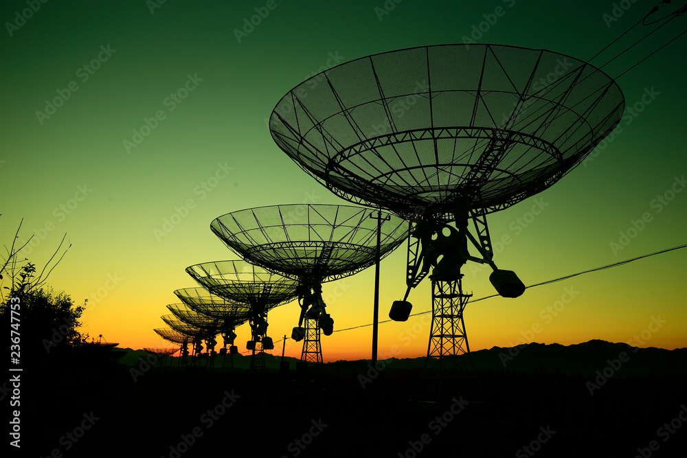 The silhouette of a radio telescope observatory The silhouette of a radio telescope observatory
