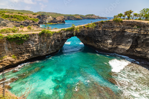Beautiful landscape of a Broken Beach, located in Nusa Penida Island, the southeast island of Bali, Indonesia. The amazing tourist attraction of the rock, cliff, mountain, and ocean waves.