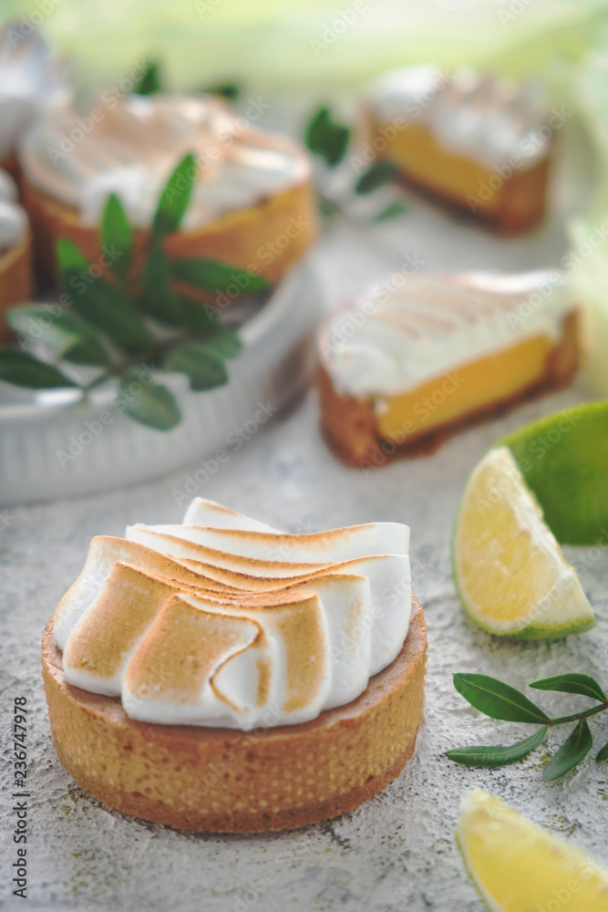 Fresh lemon tartlets with meringue on white background,  close-up. wedding dessert, decorated