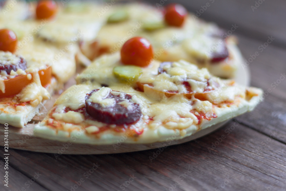 homemade traditional pepperoni pizza with salami and cheese, cherry tomatoes on top homemade traditional pepperoni pizza with salami and cheese, cherry tomatoes on top