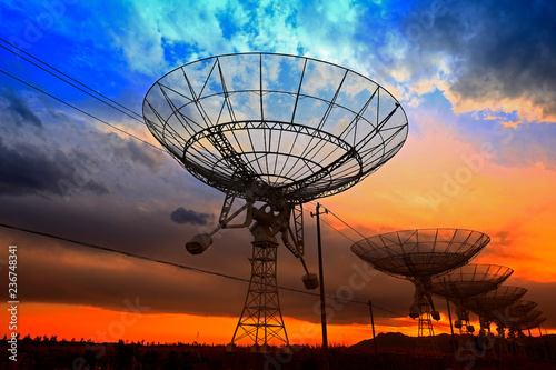 The silhouette of a radio telescope observatory