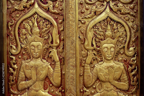 pattern on temple wall in Chiangrai temple north of Thailand with soft-focus and over light in the background