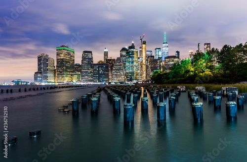 Manhattan panoramic skyline at night from Brooklyn Bridge Park. New York City, USA. Office buildings and skyscrapers at Lower Manhattan (Downtown Manhattan)..