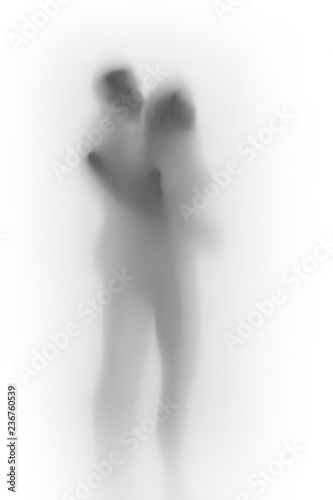 Diffuse body silhouette of a lover couple together behind a white curtain or glass surface.