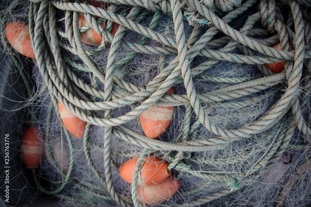 Long rope with the orange buoys lying on the pier Long rope with the orange buoys lying on the pier
