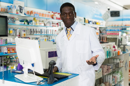 Male pharmacist invites to pharmacy