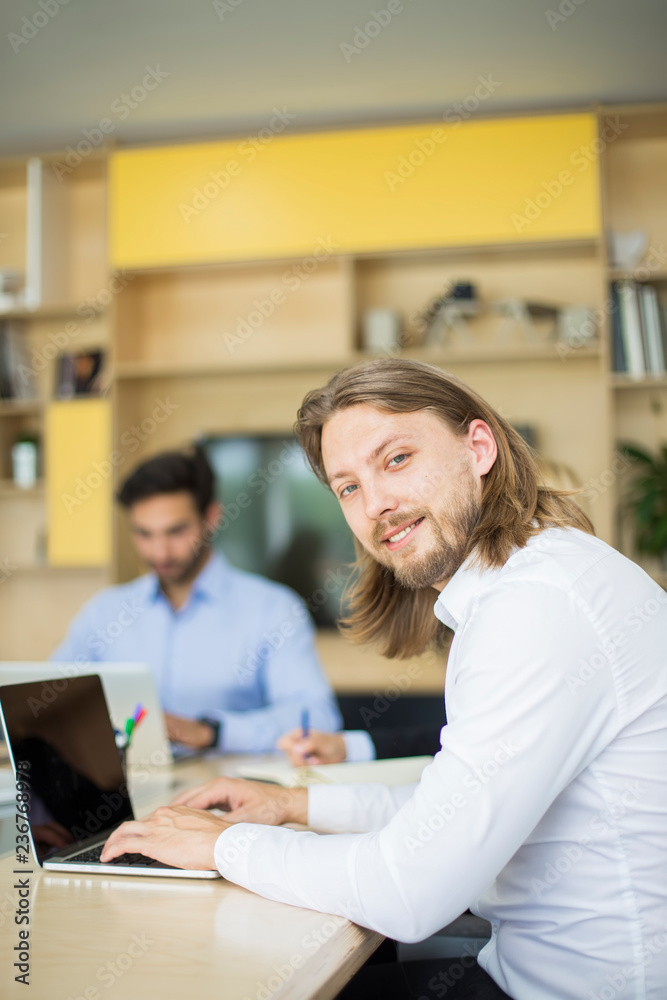 Business people working with laptop in an office Business people working with laptop in an office