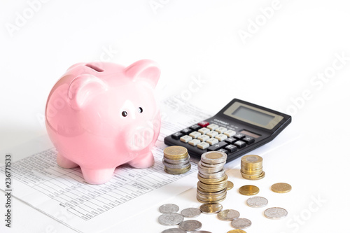 piggy bank with coins and calculator