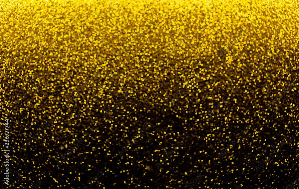 Shiny defocused sparkling golden bokeh on black background. Shiny defocused sparkling golden bokeh on black background.