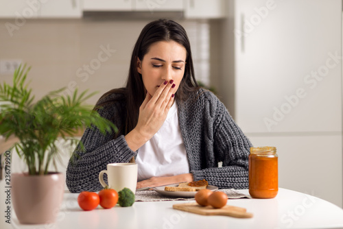 Young  woman feeling nausea during breakfast time photo